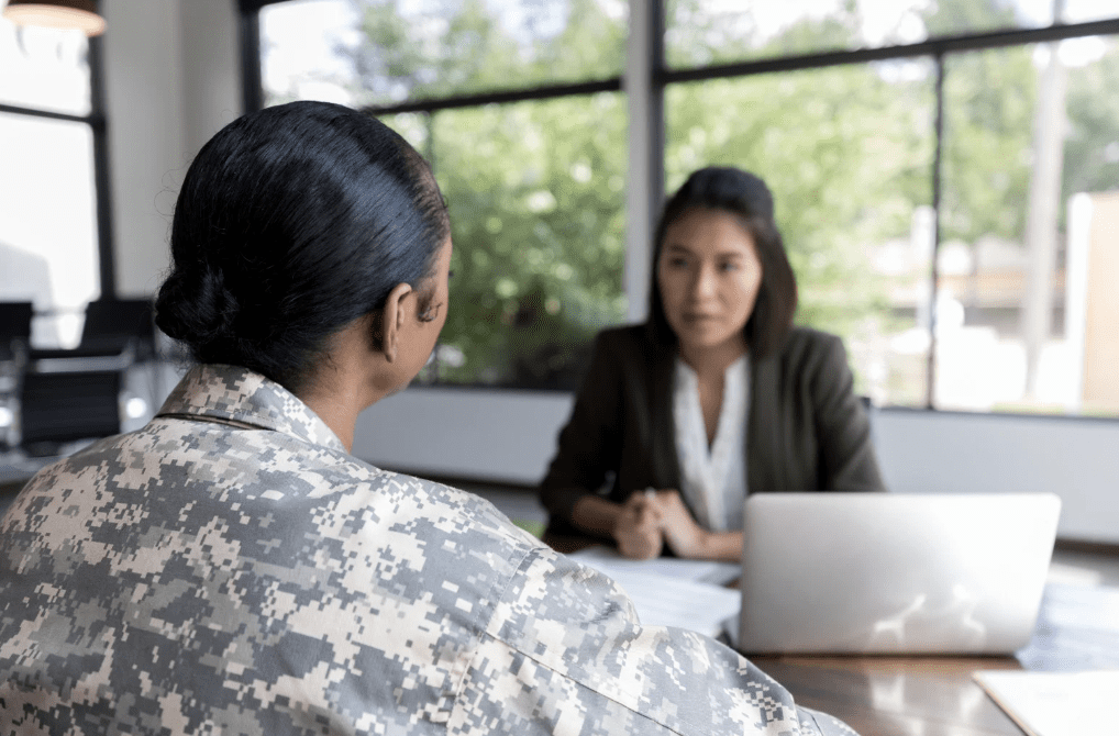 veteran A military service woman speaking with another person.